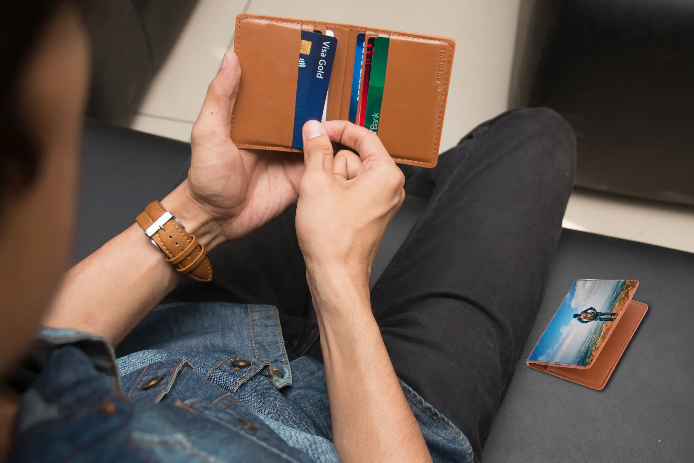 Budget traveler's wallet holding the best debit card for international travel and a backup card