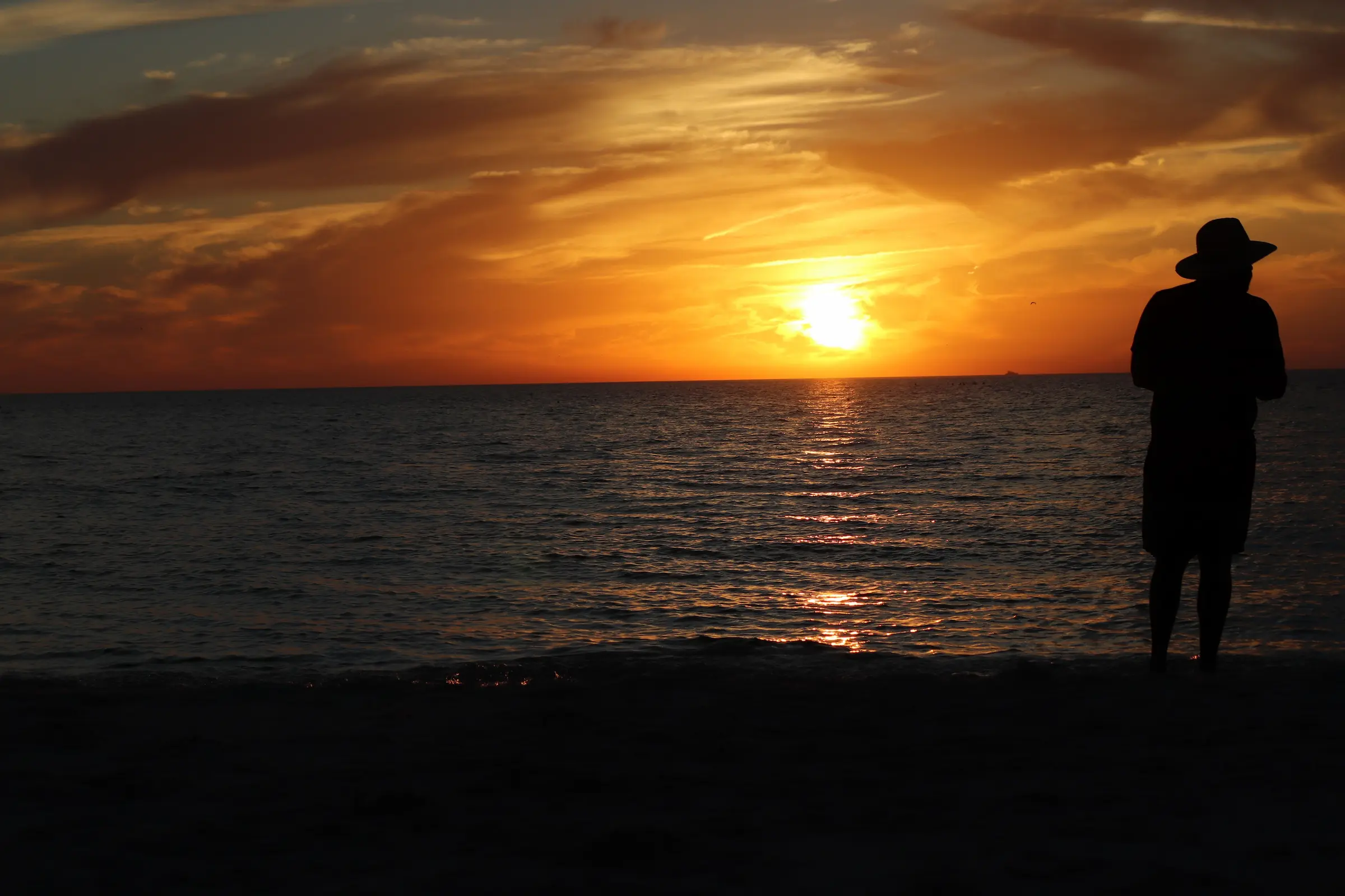 Golden sunset over a calm west coast beach, a highlight of the best beaches in Barbados and free things to do in Barbados