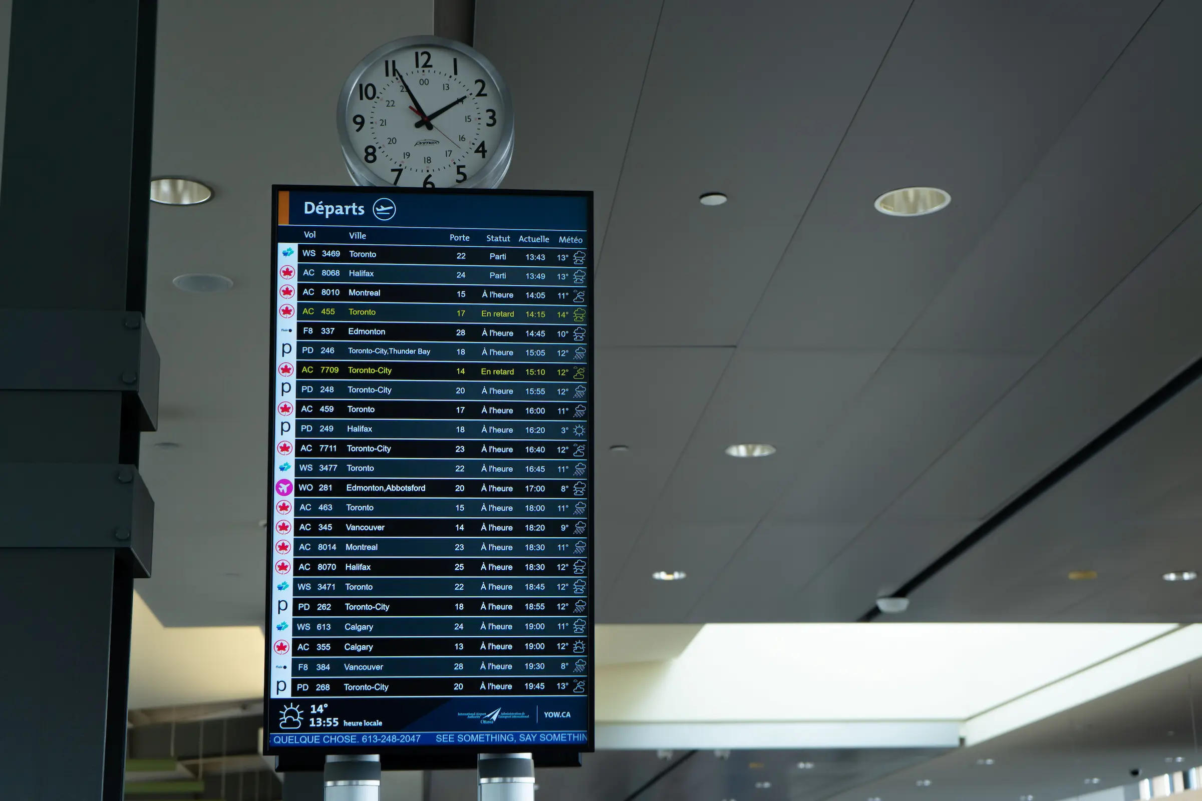 Traveler with a backpack looking at an airport departure board, planning the best time to book flights