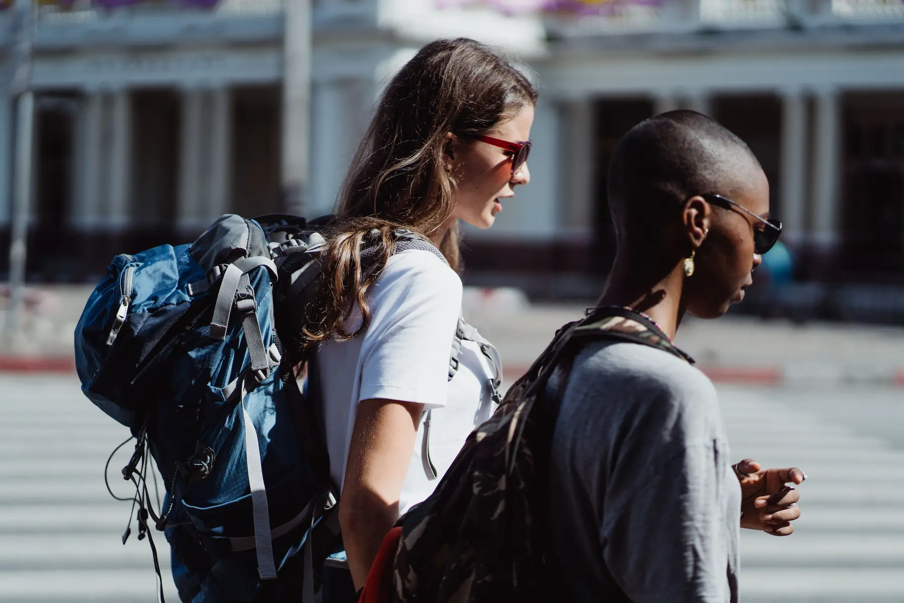 Carry on packing list: a 40L travel backpack packed with cubes on a hostel bed