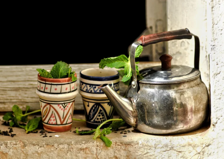 Glass of mint tea on a rooftop terrace overlooking the Fes medina at sunset, the finish line of one week in Morocco on a budget
