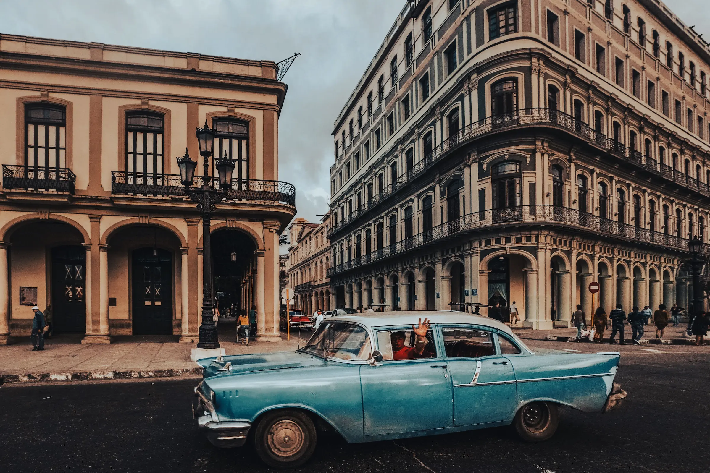 Classic American car parked on a colorful street in Havana, a common sight when you travel to Cuba