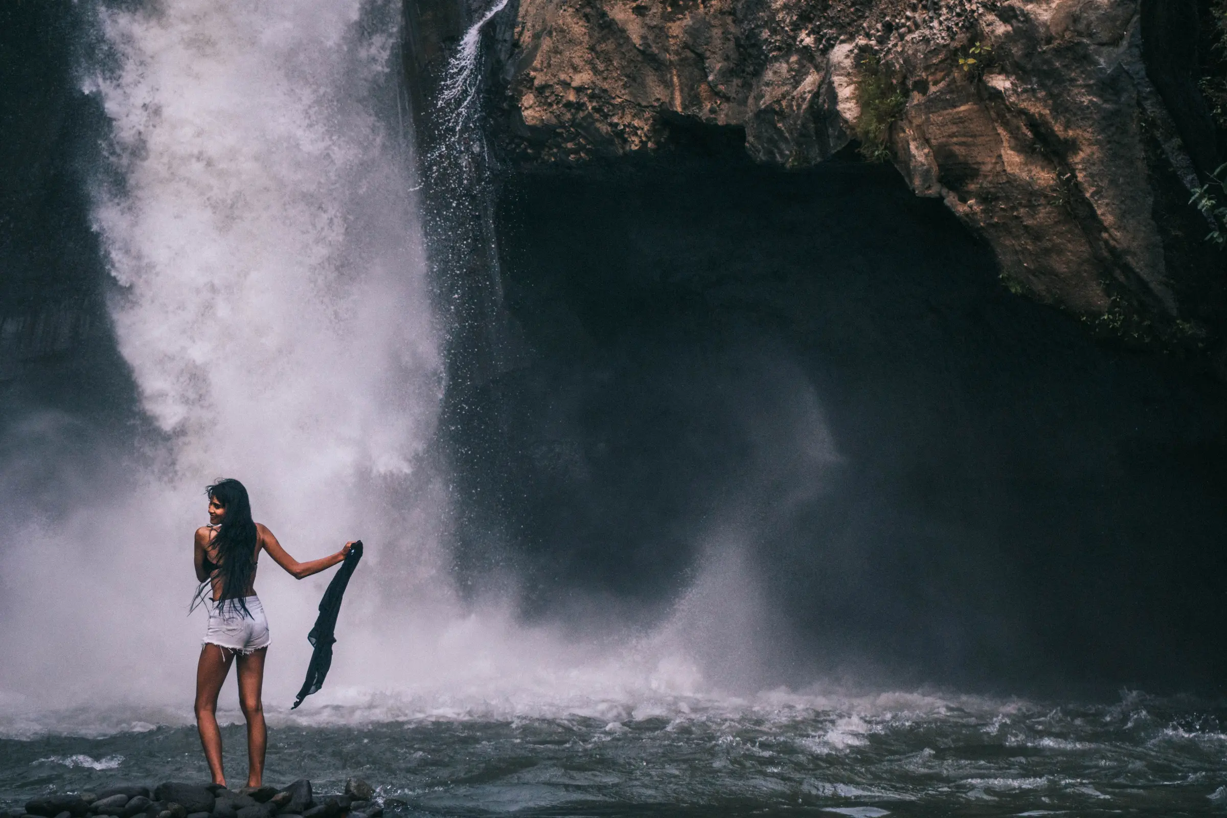 Waterfall in green forest, one of the cheap things to do in Bali
