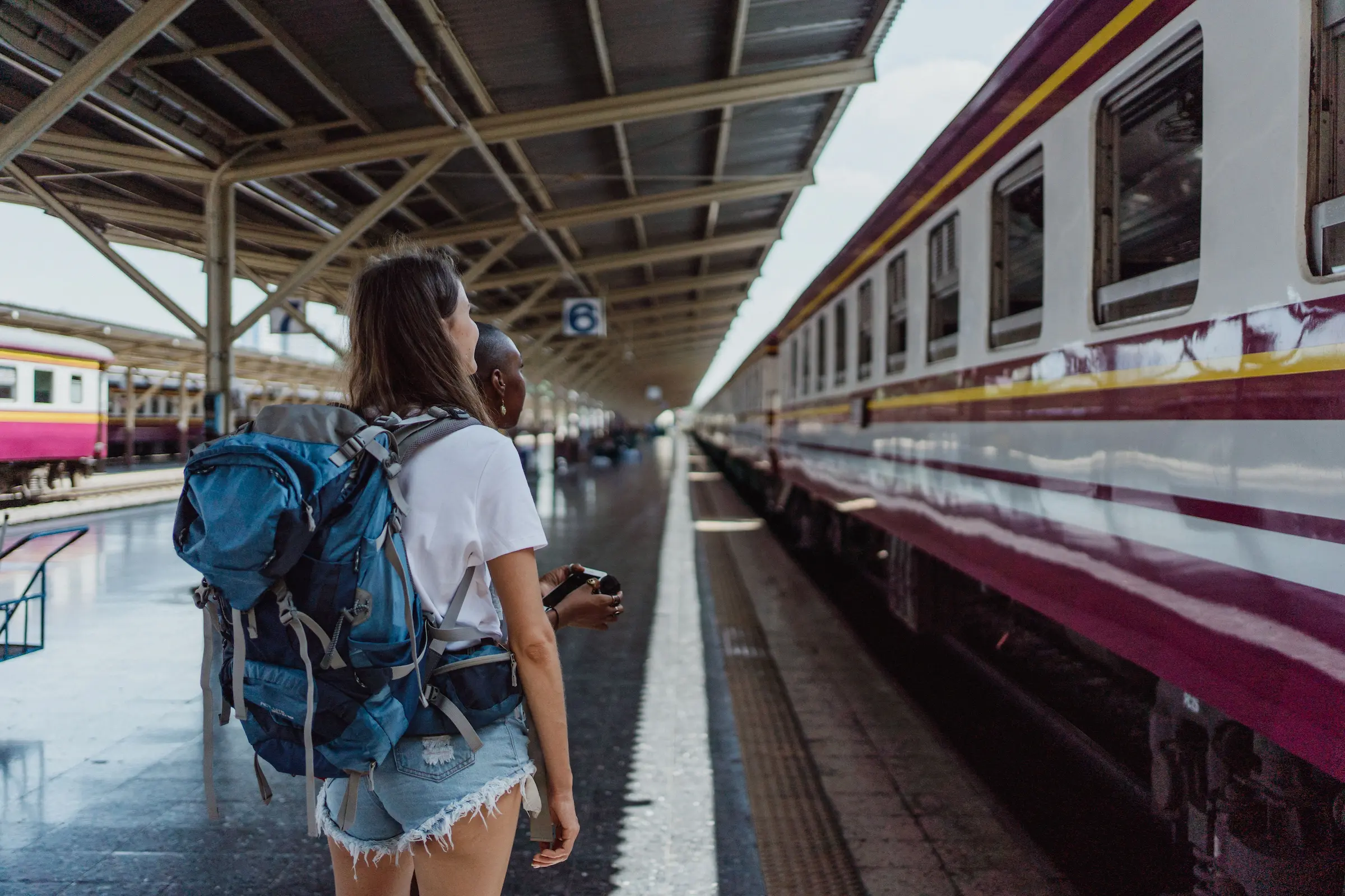 Backpacker walking through a train station during carry-on only travel