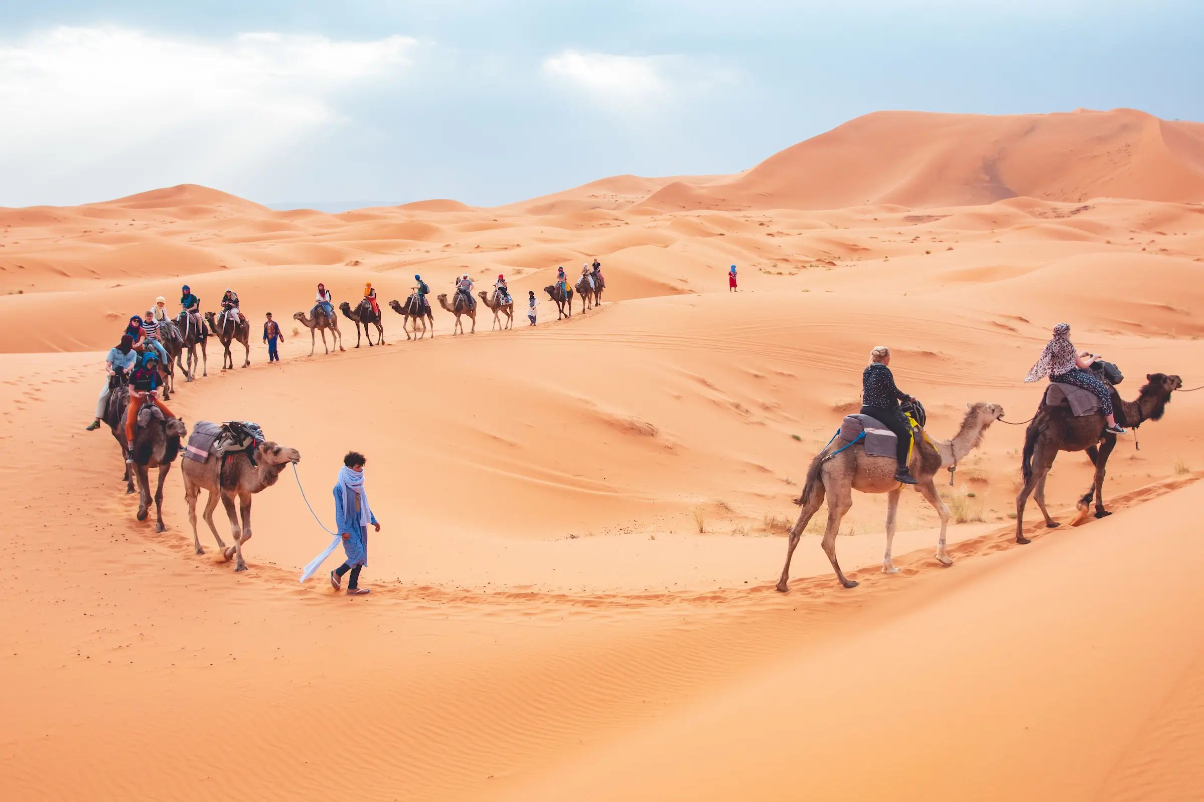 Traveler watching sunset over the Erg Chebbi dunes after a desert tour from Marrakech