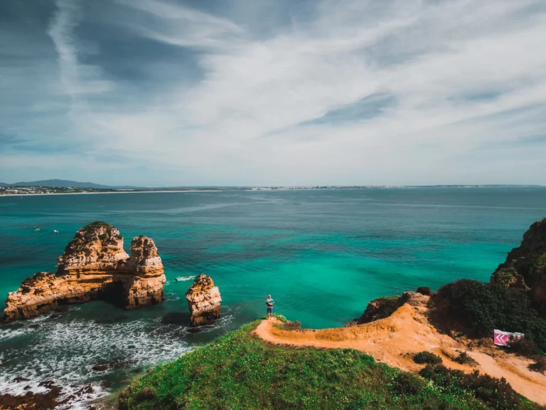 Golden sea cliffs and clear water near Lagos, a highlight of Portugal on a budget