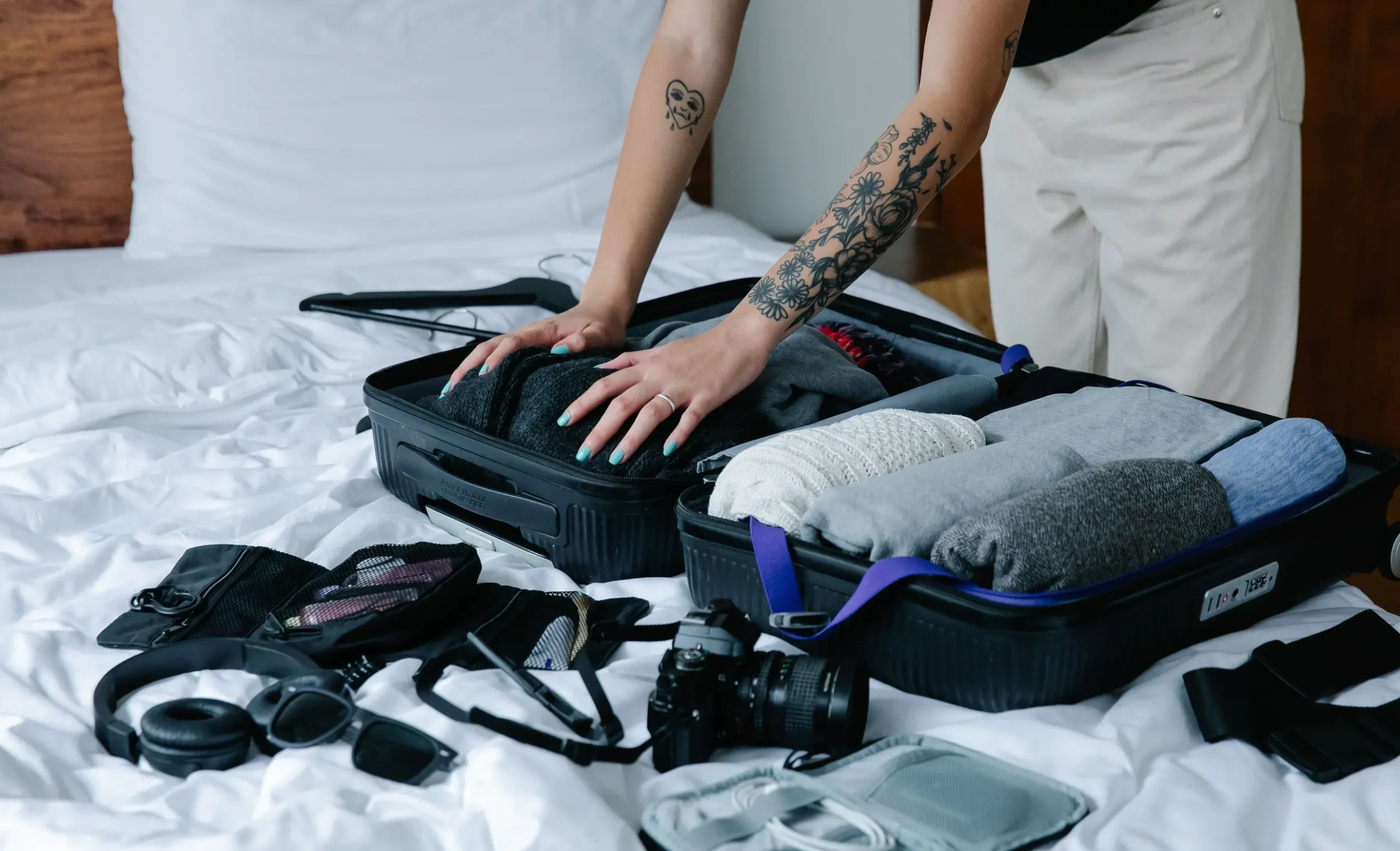 Packing cubes holding a capsule wardrobe for travel in neutral colors