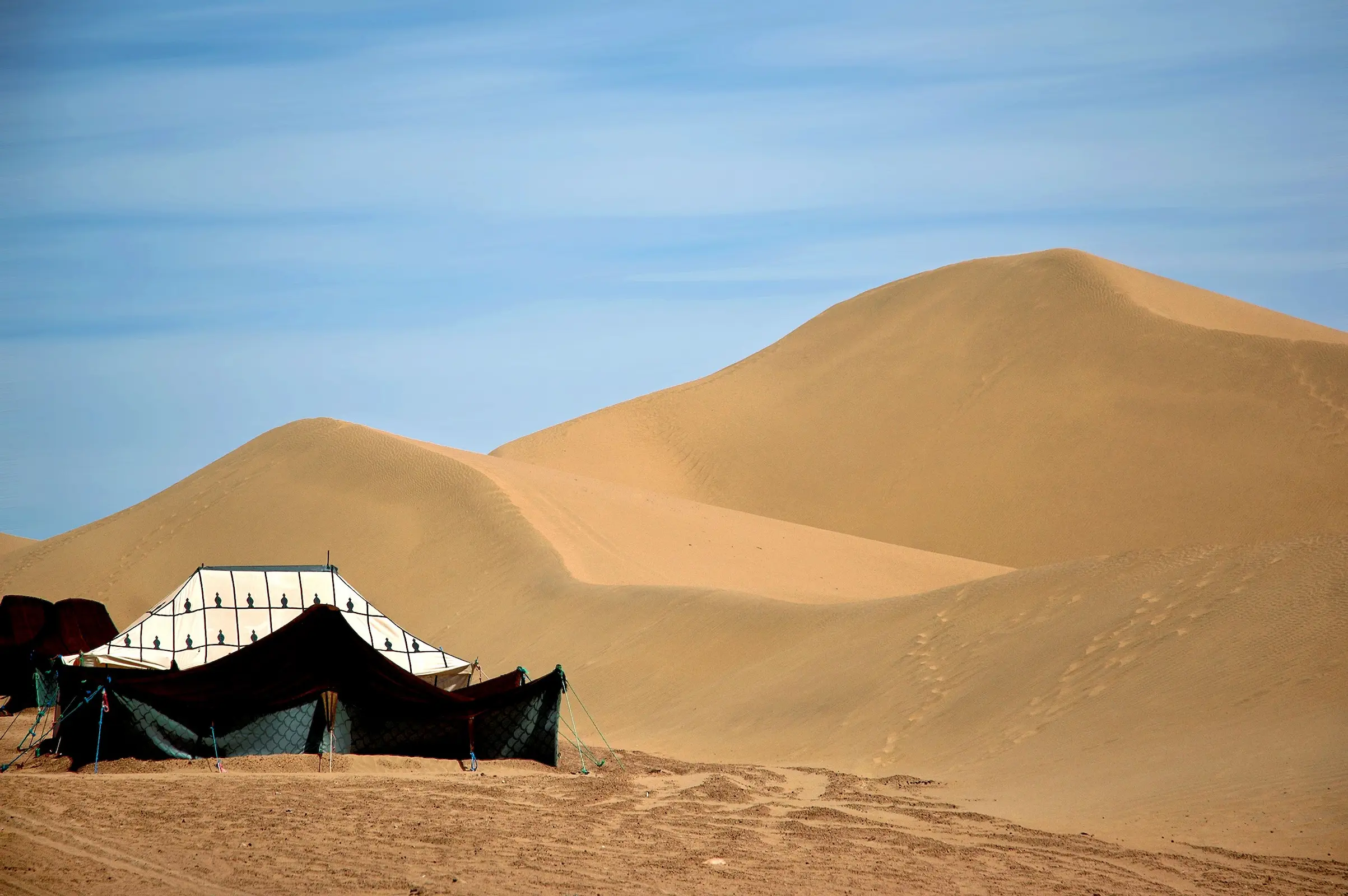 Traditional tents at a Sahara desert camp at dusk