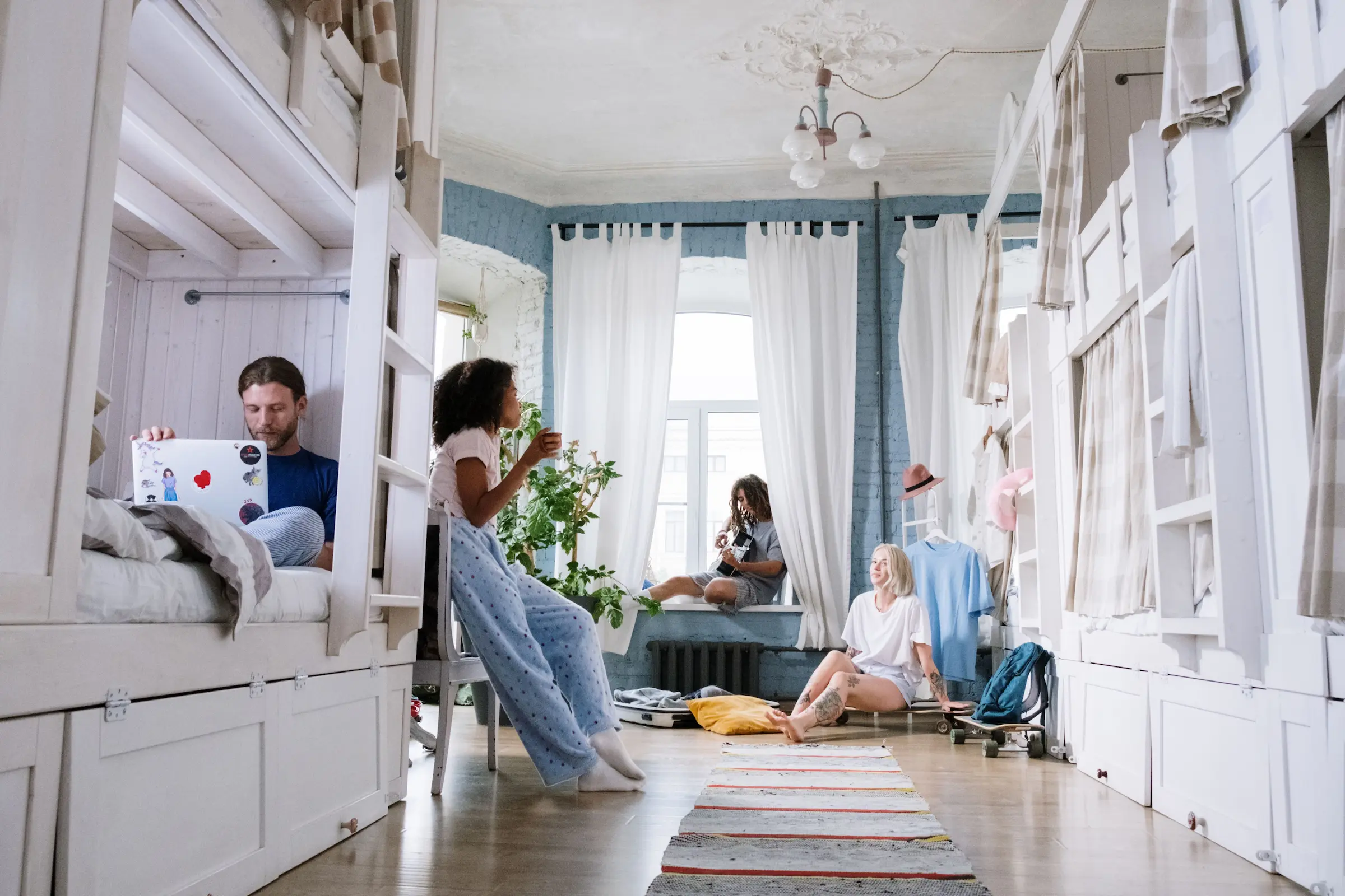 Staying in a hostel: a tidy dorm room with bunk beds and lockers