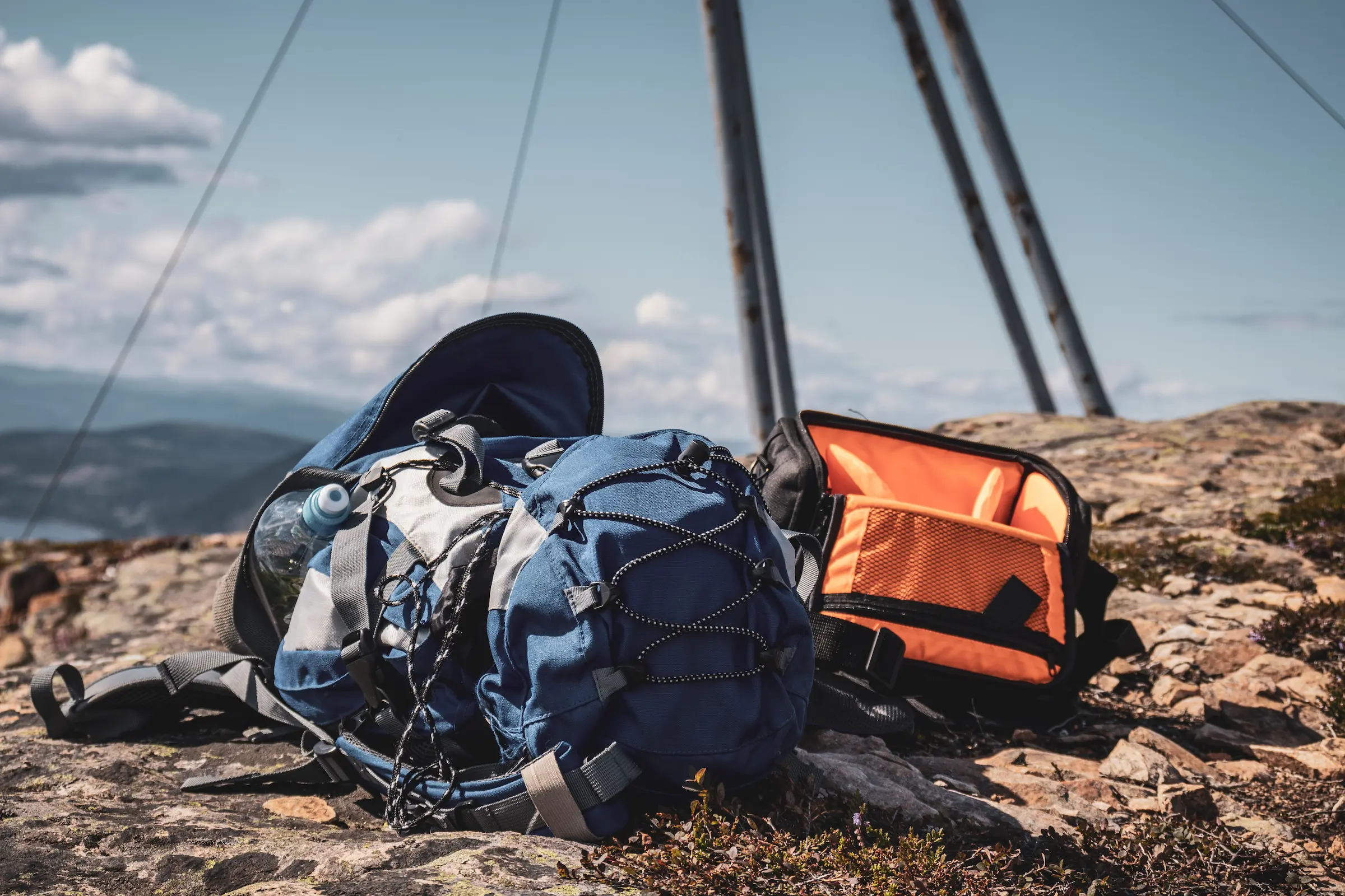 How to pack light with a minimalist packing list: an open carry-on backpack with rolled clothes